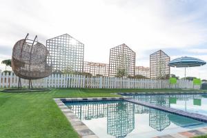 a swimming pool with a city skyline in the background at Polokwane Estate Lodge & Spa in Polokwane