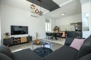sala de estar con sofá y mesa en Exceptional Apartment Juniper, FIRST ROW TO THE SEA, en Božava