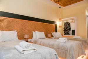 a bedroom with two beds with towels on them at Georgia Pelekanou Studios in Fira