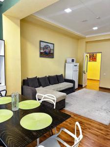 a living room with a couch and a table at Dream Inn H&A in Tashkent