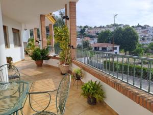 a balcony of a house with chairs and tables at Alojamiento Árdales in Frailes +22 photos