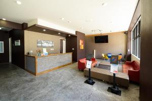 a hotel room with a lobby with a couch and a counter at Residence Hotel Naha West in Naha