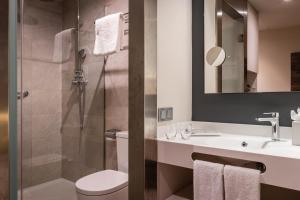 a bathroom with a toilet and a sink and a shower at Hotel SB Plaza Europa in Hospitalet de Llobregat