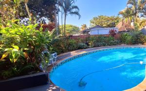 a large blue swimming pool in a yard at AveBulela Penthouse in Richards Bay