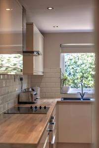 a kitchen with a sink and a window at Gwithian Holidays in Hayle