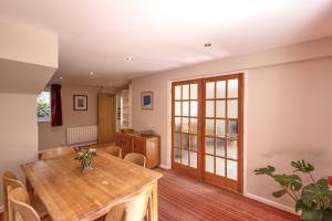 a dining room with a wooden table and chairs at Gwithian Holidays in Hayle
