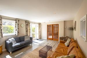 a living room with a couch and a table at Gwithian Holidays in Hayle