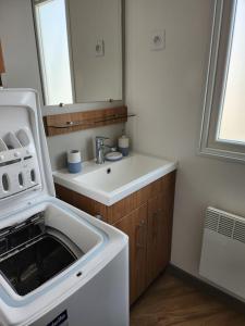 a bathroom with a sink and a microwave at Litteau 105 in Litteau +10 photos