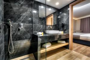 y baño con ducha y lavamanos. en Palatino Hotel en Zakynthos