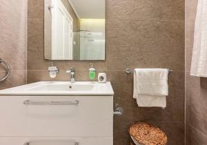 a bathroom with a sink and a mirror at Sea View Luxury Haven Living & 3Bedrooms Seafront in Sliema +25 photos