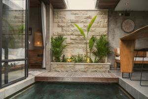 a swimming pool in a house with plants at Danu Villas Bali in Kerobokan