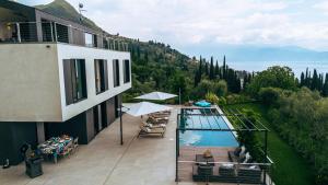 a balcony of a building with a swimming pool at Villa Dolce Vista in Gardone Riviera