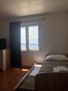 Postel nebo postele na pokoji v ubytování Apartments Curnić