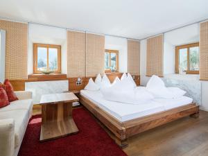 a bedroom with a large bed with white pillows at Gasthof Schopper in Breitenbach am Inn