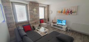 uma sala de estar com um sofá e uma televisão em FORMOSA, The boutique apartment, City Center, Pula em Pula