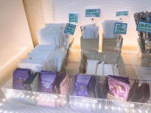 a display of purple and white candles in boxes at Karuizawa Pension Sato no Nukumori in Karuizawa