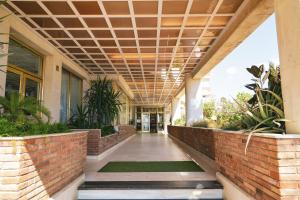 an empty hallway of a building with plants at htop Royal Sun - Fun in Santa Susanna