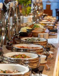 a buffet line of plates of food on a table at Arena Apart-Resort Cam Ranh with Ocean view-Private beach in Cam Ranh