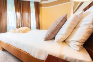 a bedroom with a bed with pillows at BRISTOL Hotel Opatija in Opatija