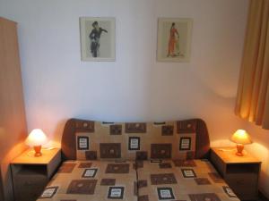 a bedroom with a bed with two lamps on two tables at Villa Am Meer EG2 in Göhren