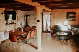 a kitchen and living room with a table and a couch at Kuća za odmor Anera in Gospić