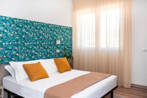 Postel nebo postele na pokoji v ubytování Nido Suite & Apartments