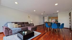 a living room with a couch and a table at Capela's House in Ribeira Brava
