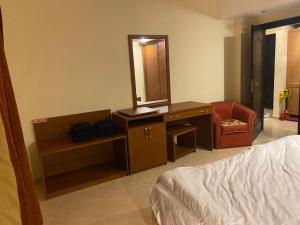 sypialnia z łóżkiem i komodą z lustrem w obiekcie Apartment Sahl Hasheesh 1+1 w mieście Hurghada