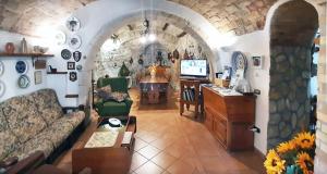 a living room with a couch and a dining room at La grotta di NiMa in Pretoro