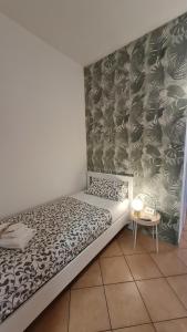 a bed in a room with a wall at B&B Verdeoliva in Modugno