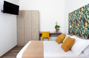Postel nebo postele na pokoji v ubytování Nido Suite & Apartments
