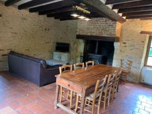 a dining room with a table and a fireplace at Gite de Foulleray n 14 in Rouez