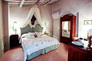 a bedroom with a large bed and a mirror at Podere La Strega in Siena