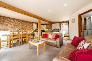 a living room with a couch and a table at Woodcock in Beccles