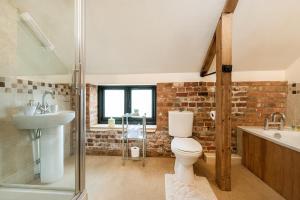 a bathroom with a toilet and a sink and a shower at Woodcock in Beccles +31 photos