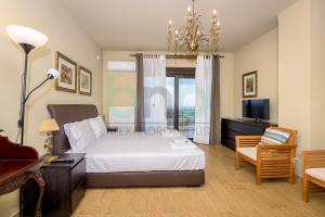 a bedroom with a bed and a desk and a tv at ''Villa Elia'' in Dhíkella