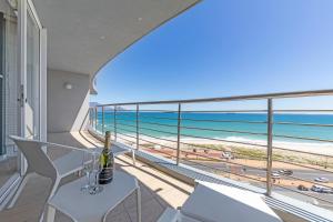 a balcony with a view of the beach and the ocean at Horizon Bay 702 in Bloubergstrand