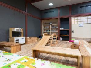 a large room with wooden tables and a kitchen at Lupo Forest "GRAN FOREST Echizen Miyama" - Vacation STAY 06371v in Fukui