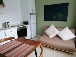 a living room with a couch and a table at Fair Haven Guest Suite Self-catering in Marina Beach