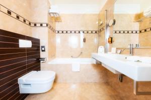 a bathroom with a toilet and a sink and a tub at BRISTOL Hotel Opatija in Opatija