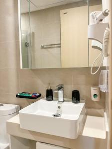 a bathroom with a white sink and a mirror at Mochi House - Căn hộ The Sóng in Vung Tau