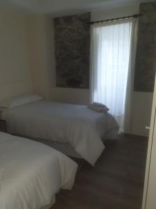 Cama o camas de una habitación en La Casa de Ana en Fisterra