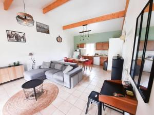 een woonkamer met een bank en een tafel bij Les Hauts de Sarlat G4 - Clim Piscine Parking WiFi in Sarlat-la-Canéda