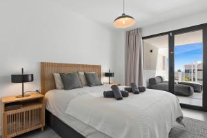 ein Schlafzimmer mit zwei Betten und einem großen Fenster in der Unterkunft Luxury Seaview Resort Apartment in Manilva + 30 Fotos