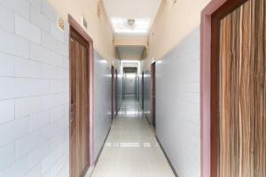 an empty corridor of a hospital hallway with doors at OYO Jayanthi Mansion in Chennai
