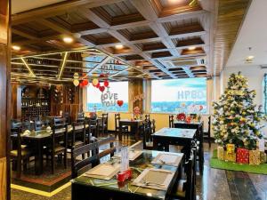 a restaurant with a christmas tree in the middle at Hapyson in Long Khanh