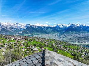 a view of a town with mountains in the background at Chalet Agneau by Interhome in Nendaz