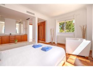 sypialnia z białym łóżkiem i dużym lustrem w obiekcie Holiday Home Cala Mesquida - CDE140 by Interhome w Cala Mesquida