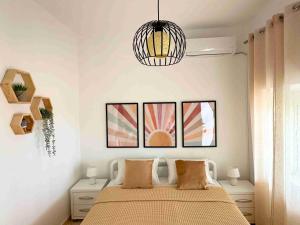 a bedroom with a bed and a pendant light at Kalderimi View House in Dhërmi