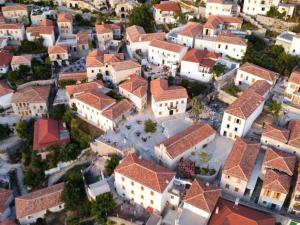an aerial view of a village with buildings at Kalderimi View House in Dhërmi